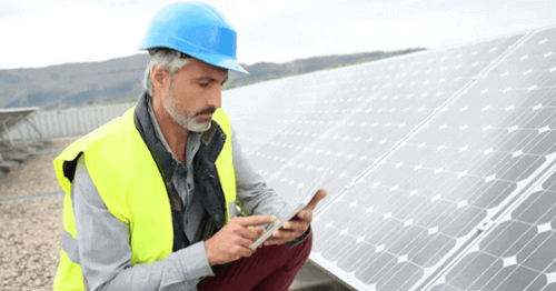 Government contractor works on solar panel