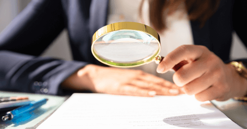 Hand with magnifying glass