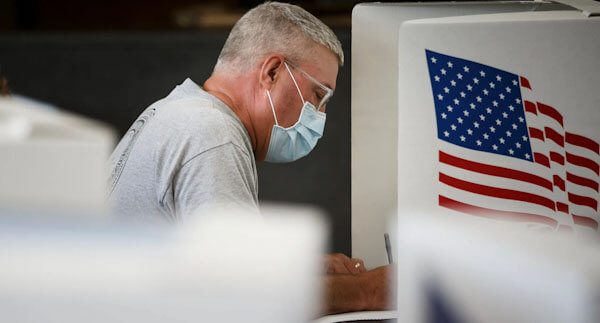 Man Voting in Mask | CSG Partners