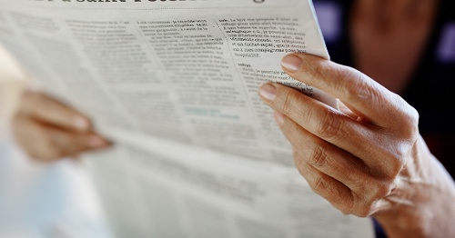 Reading newspaper.